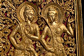 Wat Xieng Thong temple in Luang Prabang, Laos. Detail of the  gilded wood carvings of the facade of the Royal Funerary carriage hall. 